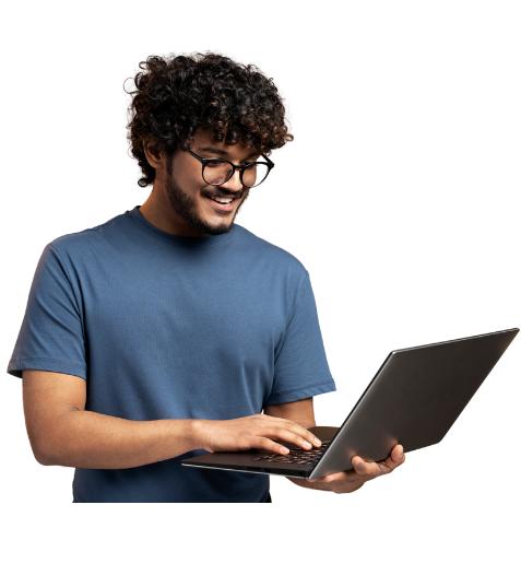 Smiling young man holding a laptop and looking at the screen, representing practical digital marketing learning.